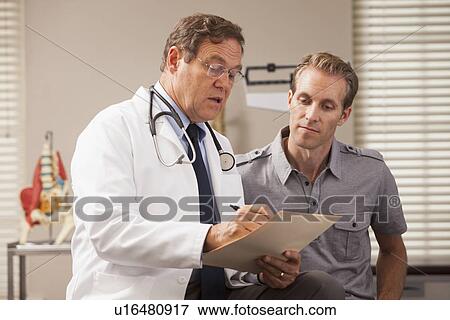 Doctor consulting with patient View Large Photo Image Stock Photo - Doctor consulting with patient. Fotosearch