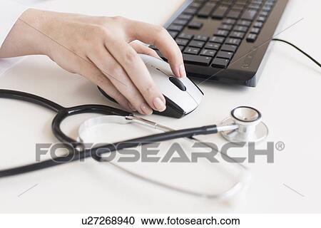 Doctor using computer View Large Photo Image Stock Image - Doctor using computer. Fotosearch