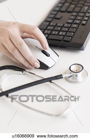 Doctor using computer View Large Photo Image Stock Photo - Doctor using computer. Fotosearch
