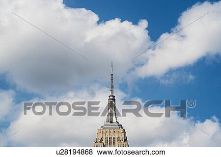 Empire State Building under blue sky View Large Photo Image Stock Photo - Empire State Building under blue sky. Fotosearch