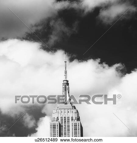 Empire State Building under cloudy sky View Large Photo Image Stock Photo - Empire State Building under cloudy sky. Fotosearch