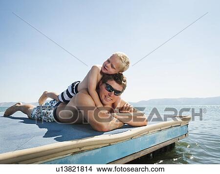 Father with son sunbathing View Large Photo Image Picture - Father with son sunbathing. Fotosearch