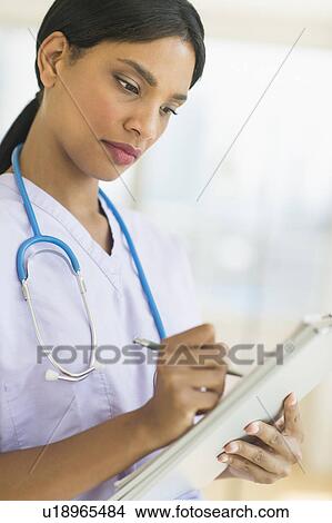 Female doctor holding clipboard View Large Photo Image Picture - Female doctor holding clipboard. Fotosearch