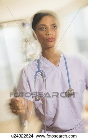Female doctor rushing with iv drip View Large Photo Image Picture - Female doctor rushing with iv drip. Fotosearch