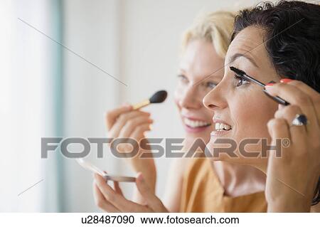 Female friends during applying make-up View Large Photo Image Stock Image - Female friends during applying make-up. Fotosearch