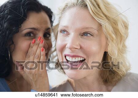 Female friends gossiping View Large Photo Image Stock Image - Female friends gossiping. Fotosearch
