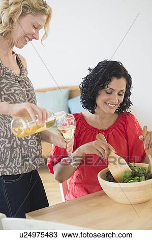 Female friends preparing salad View Large Photo Image Stock Image - Female friends preparing salad. Fotosearch