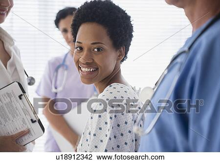 Female patient among hospital staff View Large Photo Image Stock Image - Female patient among hospital staff. Fotosearch