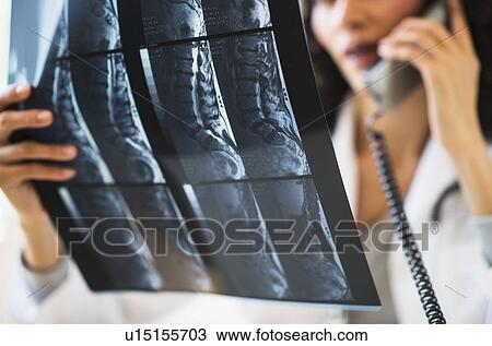 Female radiologist consulting MRI scan View Large Photo Image Stock Image - Female radiologist consulting MRI scan. Fotosearch