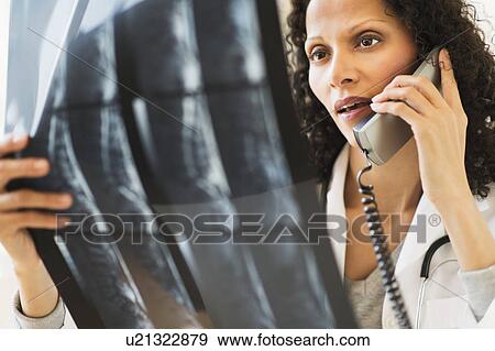 Female radiologist consulting MRI scan View Large Photo Image Stock Photo - Female radiologist consulting MRI scan. Fotosearch