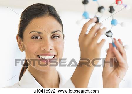 Female scientist holding molecule model View Large Photo Image Stock Image - Female scientist holding molecule model. Fotosearch