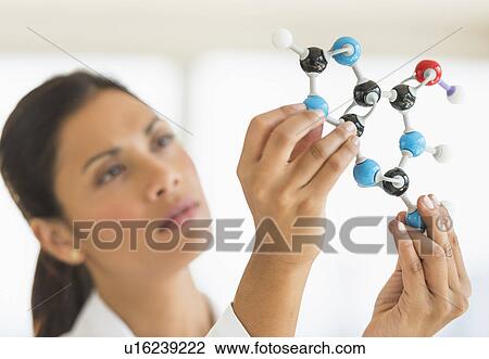 Female scientist holding molecule model View Large Photo Image Stock Image - Female scientist holding molecule model. Fotosearch