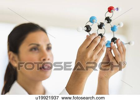 Female scientist holding molecule model View Large Photo Image Stock Photo - Female scientist holding molecule model. Fotosearch