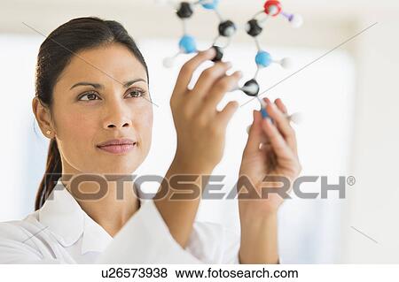 Stock Photo - Female scientist holding molecule model. Fotosearch