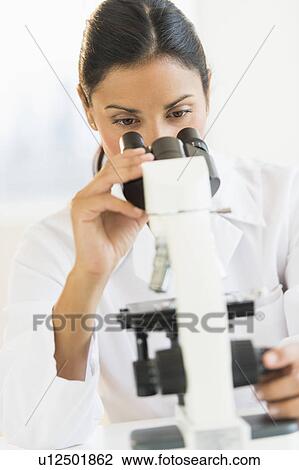 Female scientist looking through microscope View Large Photo Image Stock Image - Female scientist looking through microscope. Fotosearch
