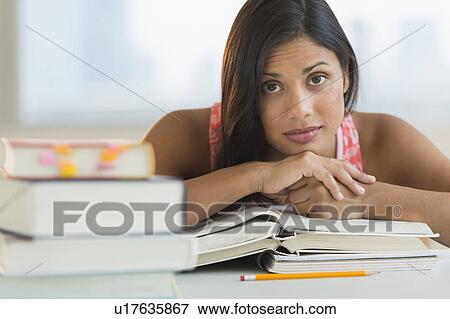 Female student leaning on books View Large Photo Image Stock Photo - Female student leaning on books. Fotosearch