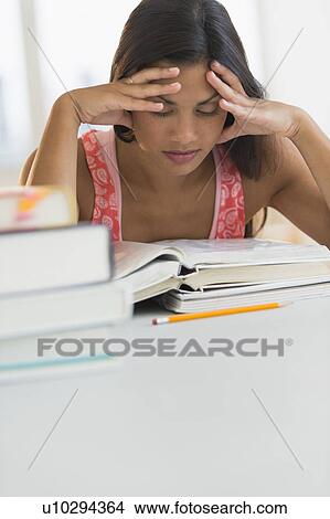 Picture - Female student reading book. Fotosearch