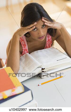 Stock Photo - Female student reading book. Fotosearch