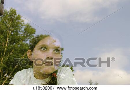 Girl (8-9) looking through window View Large Photo Image Stock Photo - Girl (8-9) looking through window. Fotosearch