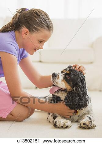 Girl (8-9) playing with her dog View Large Photo Image Stock Image - Girl (8-9) playing with her dog . Fotosearch