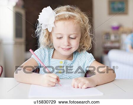 Girl drawing at table and smiling View Large Photo Image Stock Photo - Girl drawing at table and smiling. Fotosearch