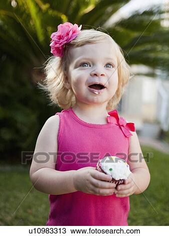 Girl holding cupcake View Large Photo Image Stock Image - Girl holding cupcake. Fotosearch