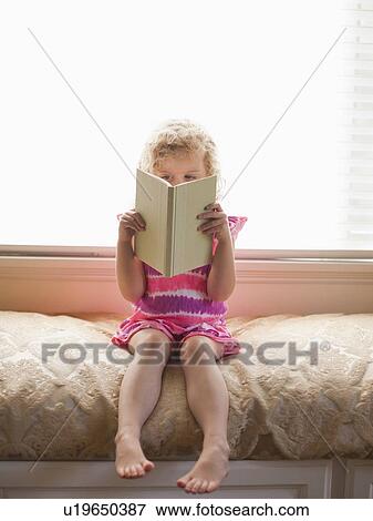 Girl sitting and reading book View Large Photo Image Stock Photo - Girl sitting and reading book. Fotosearch