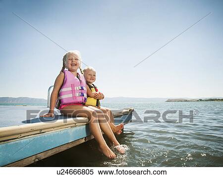 Girls (2-3, 4-5) sitting at the edge of raft in life jackets View Large Photo Image Stock Photography - Girls (2-3, 4-5) sitting at the edge of raft in life jackets. Fotosearch