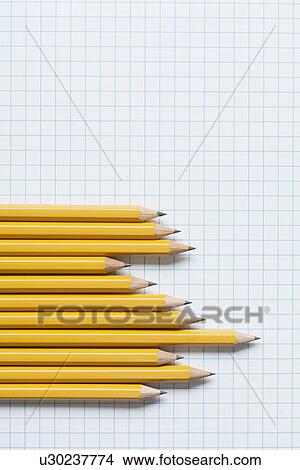 Picture - Grouping of yellow pencils in graph shape on graph paper. Fotosearch