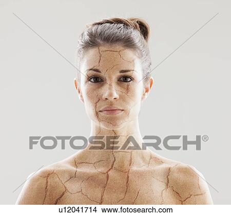 Picture - Head and shoulders shot of woman with cracked skin. Fotosearch