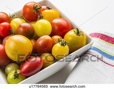 Stock Photography - Heirloom tomatoes in plate, studio shot. Fotosearch