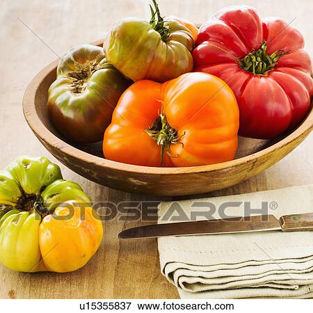 Stock Photo - Heirloom tomatoes on kitchen table. Fotosearch