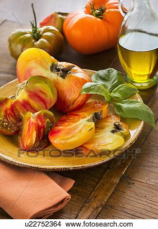 Picture - Heirloom tomatoes on plate. Fotosearch