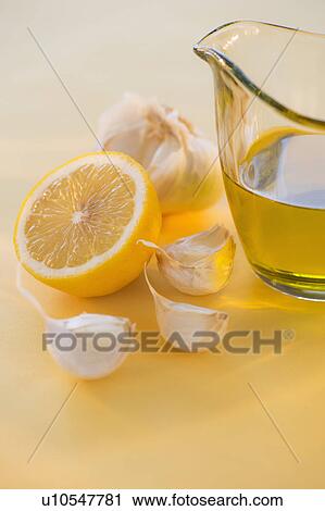 Stock Image - Lemon, garlic and jar of honey. Fotosearch