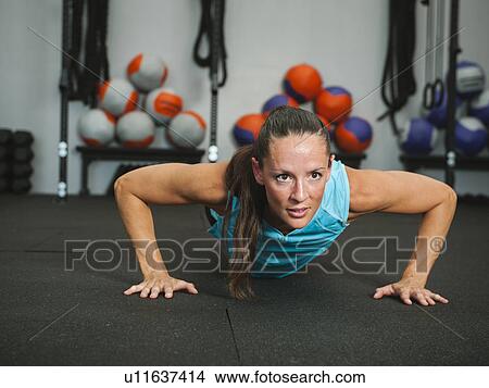 Mad adult woman doing push-ups View Large Photo Image Picture - Mad adult woman doing push-ups. Fotosearch