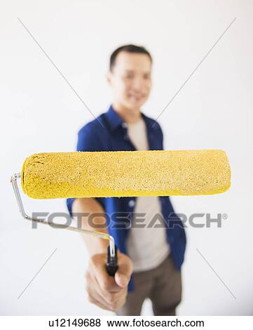 Man holding painting roll View Large Photo Image Stock Photo - Man holding painting roll. Fotosearch