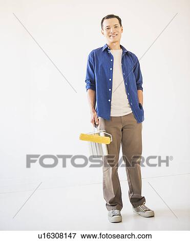 Man holding painting roll View Large Photo Image Stock Photo - Man holding painting roll. Fotosearch