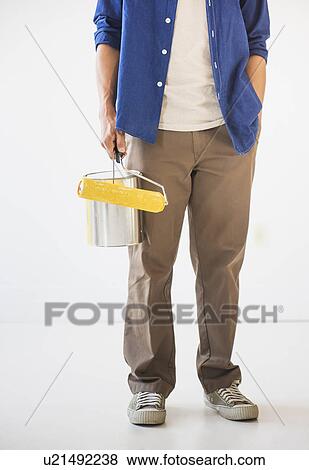 Stock Photo - Man holding painting roll. Fotosearch
