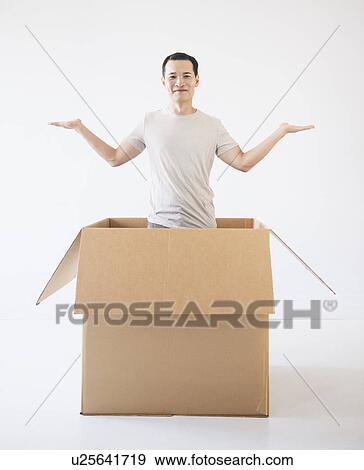 Man popping out from cardboard box View Large Photo Image Stock Photo - Man popping out from cardboard box. Fotosearch