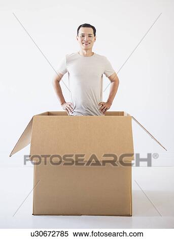 Man popping out from cardboard box View Large Photo Image Stock Photography - Man popping out from cardboard box. Fotosearch