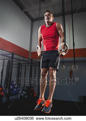 Mature man doing pull-ups with acrobatic rings View Large Photo Image Stock Photograph - Mature man doing pull-ups with acrobatic rings. Fotosearch