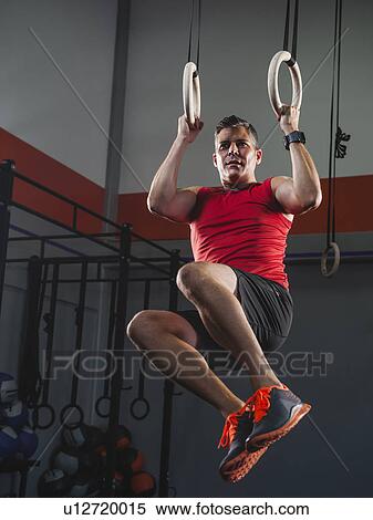 Mature man doing pull-ups with acrobatic rings View Large Photo Image Stock Photography - Mature man doing pull-ups with acrobatic rings. Fotosearch