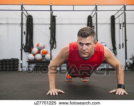 Stock Photography - Mature man doing push-ups. Fotosearch