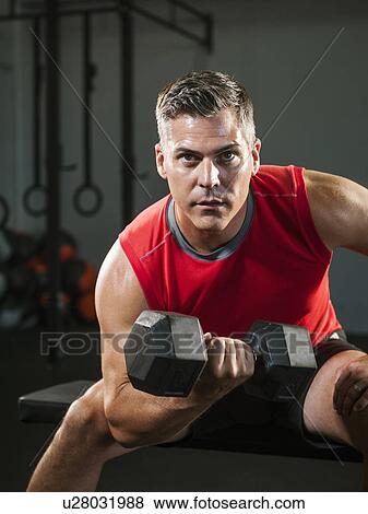 Mature man exercising with dumbbells View Large Photo Image Stock Photo - Mature man exercising with dumbbells. Fotosearch