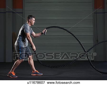 Mature man exercising with rope View Large Photo Image Stock Photo - Mature man exercising with rope. Fotosearch