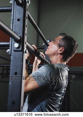 Mature man pulling him up View Large Photo Image Stock Photograph - Mature man pulling him up . Fotosearch
