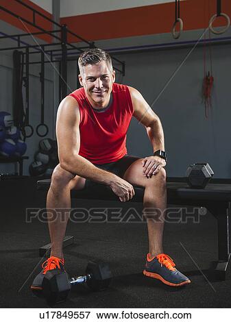 Stock Photo - Mature man taking break from exercising . Fotosearch
