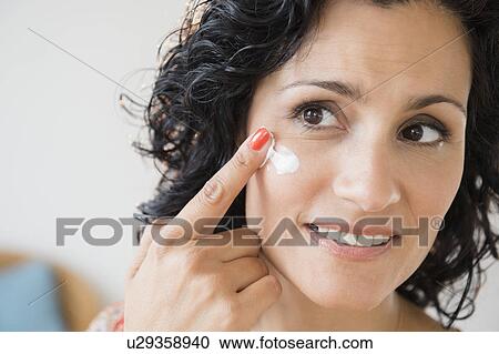 Mature woman applying anti-ageing cream View Large Photo Image Stock Image - Mature woman applying anti-ageing cream. Fotosearch