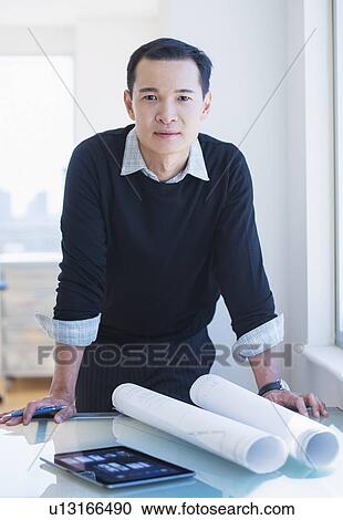 Mid adult architect working in his studio View Large Photo Image Stock Image - Mid adult architect working in his studio. Fotosearch