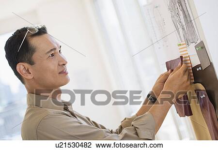 Mid adult fashion designer at work View Large Photo Image Stock Image - Mid adult fashion designer at work. Fotosearch